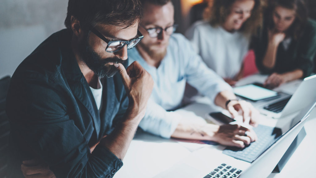 team analysing data from a computer